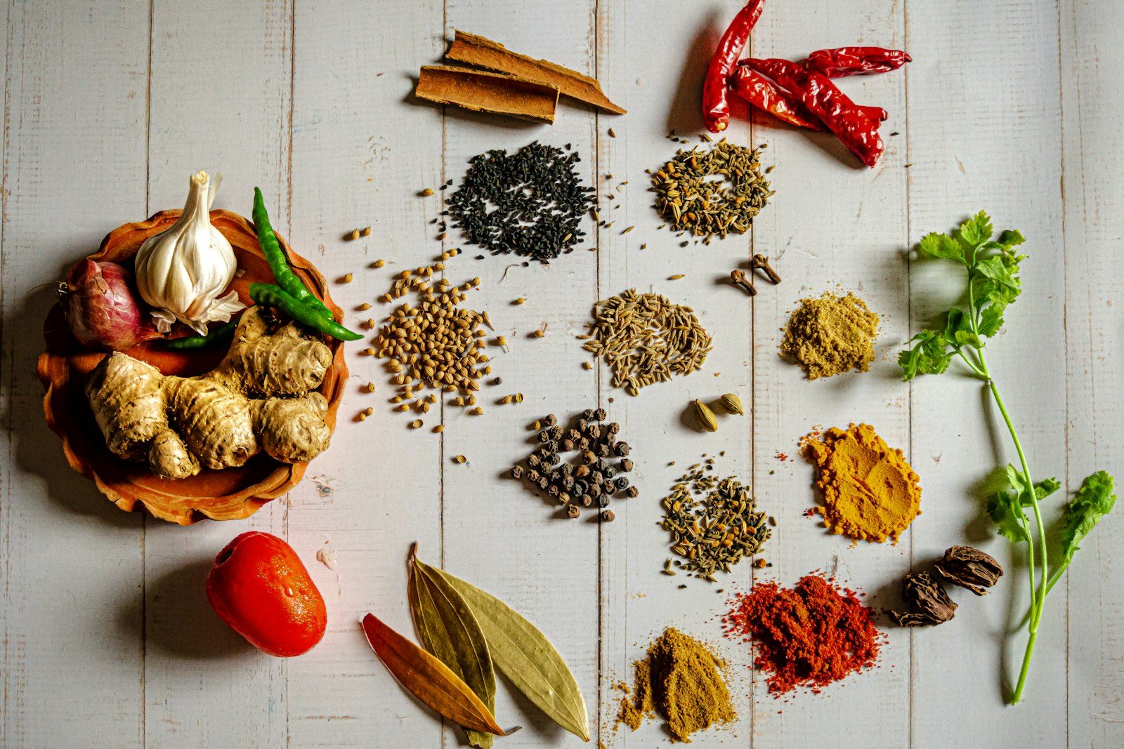 A warm flatlay of whole Indian spices ready for packing