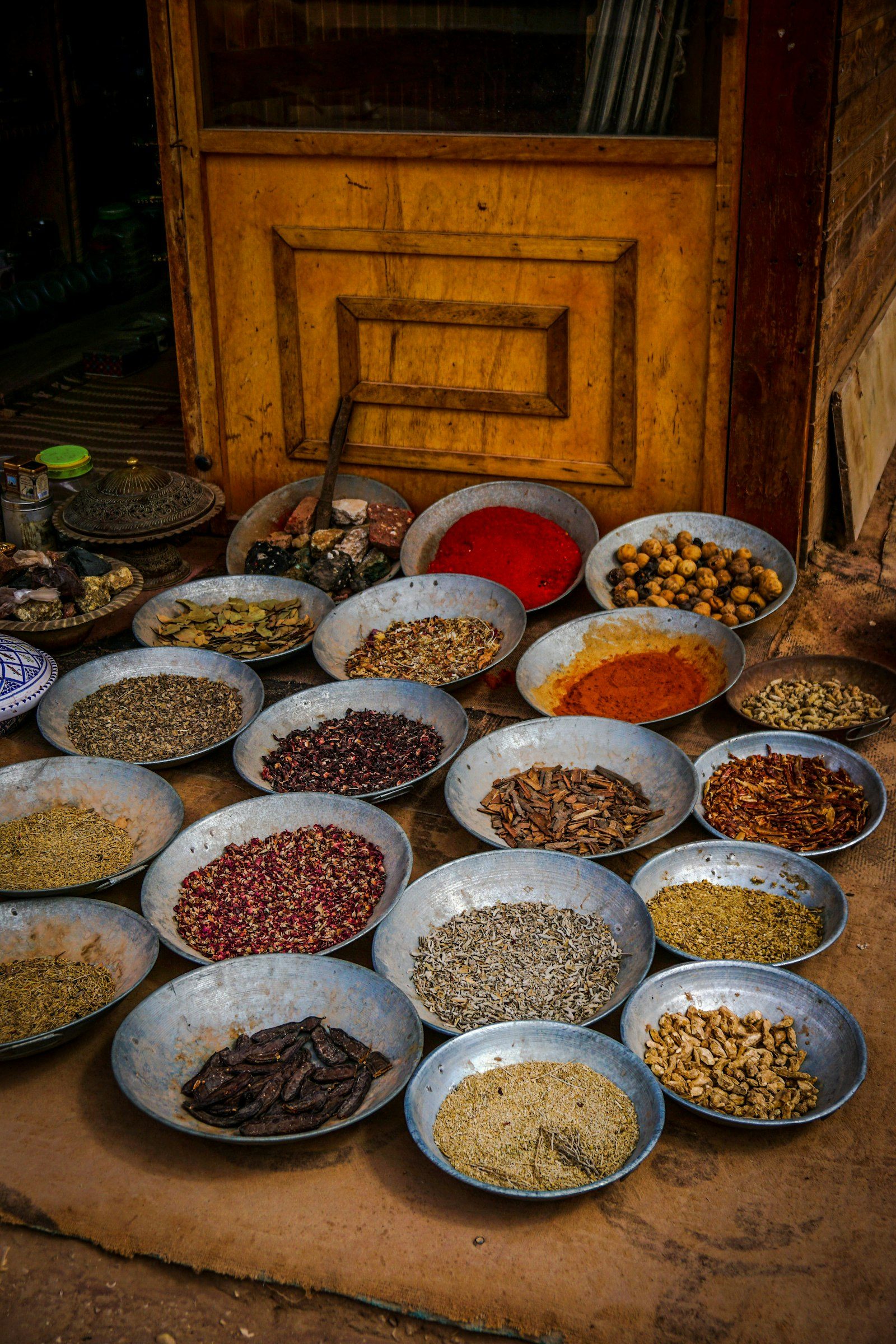 Bowls of colourful whole and ground spices at a traditional spice market